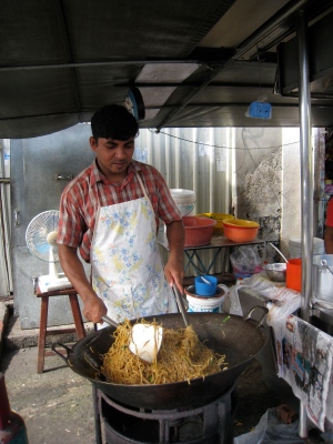 A street hawker cooking up his specialty